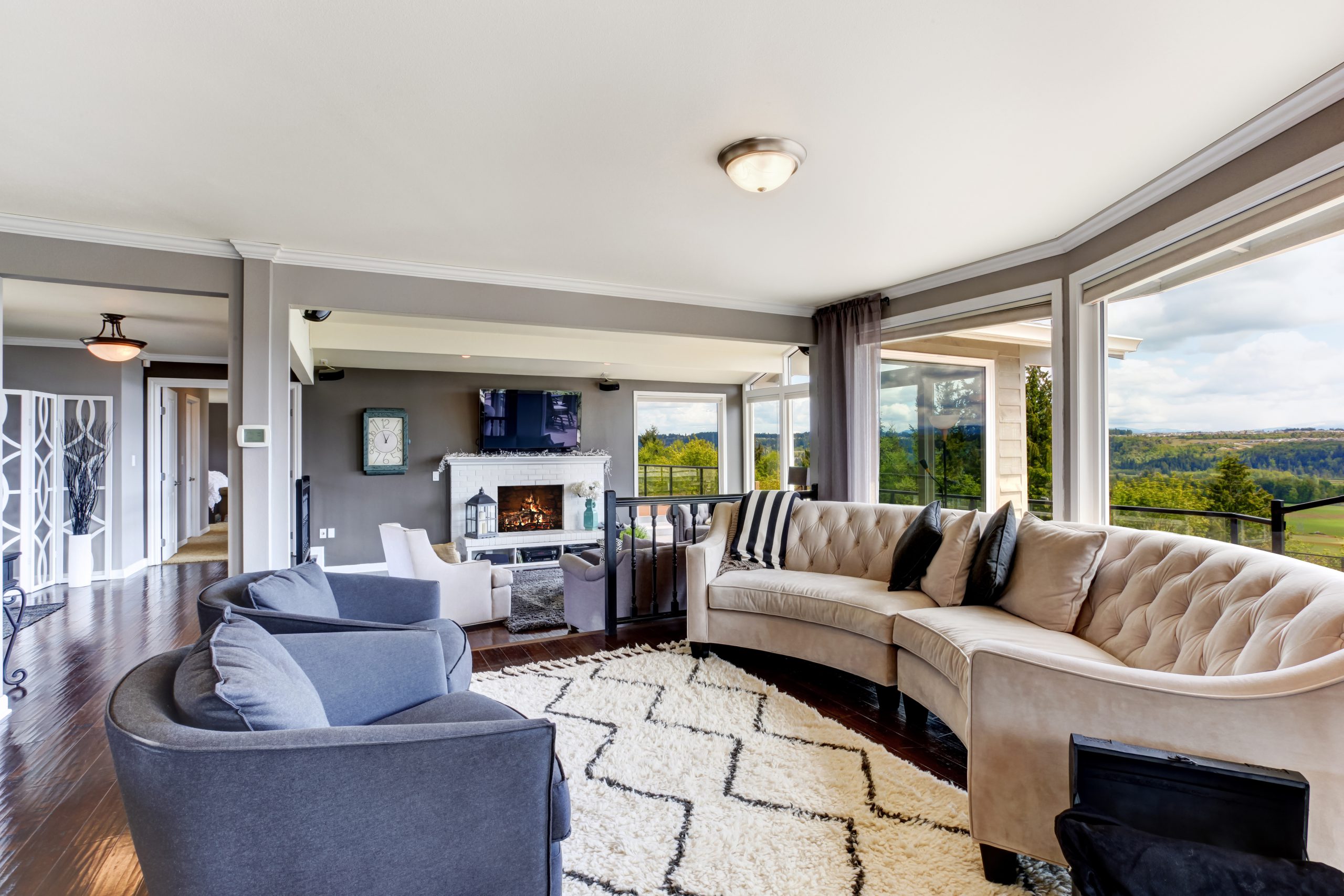 Bright elegant living room interior with white and lavender furniture, fireplace and tv